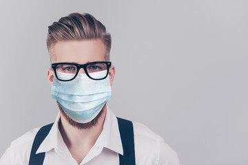 Close up portrait of handsome guy in blue face mask isolated on gray background