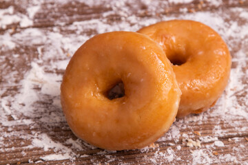 fresh donuts on wood with flour