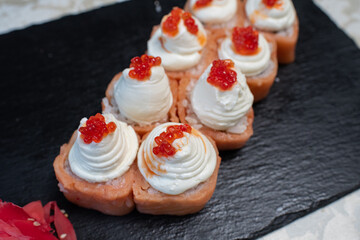 Delicious, juicy and appetizing Philadelphia rolls deluxe with red caviar