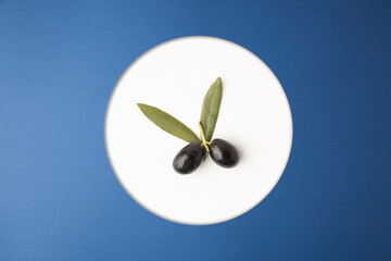 black olives, on blue background