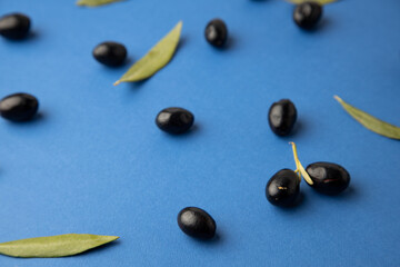 black olives, on blue background