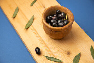 black olives, on blue background