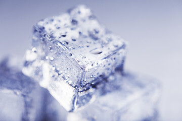 Obraz premium Ice with meltwater drops close-up on a white background.