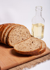 Whole grain bread sandwiches with ricotta cheese, tomato, arugula. On a wooden board. White background.
