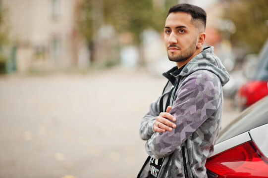 Student kuwaiti man wear at hoodie stand near car.