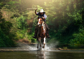 Western cowboy riding in the water