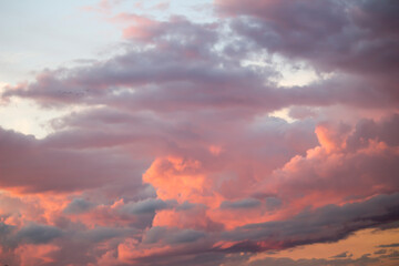 Naklejka na ściany i meble Dramatic big clouds in the vast sunset sky