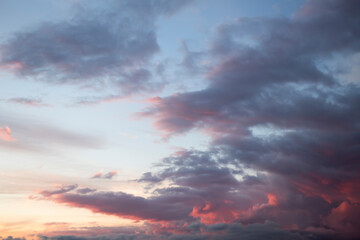 Naklejka na ściany i meble Dramatic big clouds in the vast sunset sky