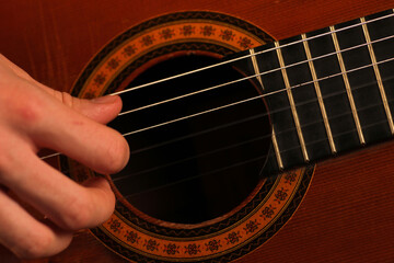 Obraz premium Person playing classic acoustic guitar