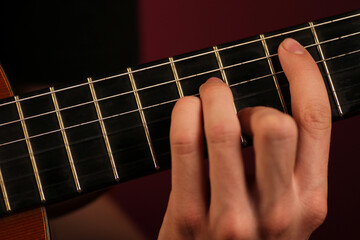 Fototapeta premium Person playing classic acoustic guitar