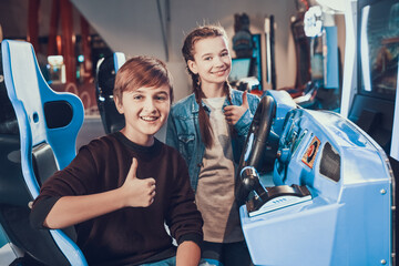 Brother and sister in playroom smiling. 