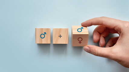 Wooden cubes with the image of a male and female gender sign. The choice of the person: relationship with a man or a woman