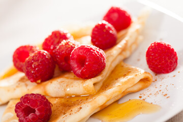 delicious  pancakes with fresh raspberries and honey