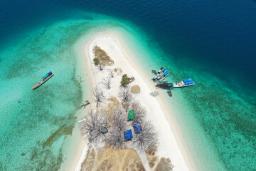 Aerial view of beautiful clear water and white beach with boats in summer of tropical island