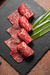 Fresh raw beef brisket slice set on the black marble dish rock. healthy and raw food concept