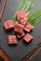 Obraz na płótnie Canvas Fresh raw beef brisket slice set on the black marble dish rock. healthy and raw food concept