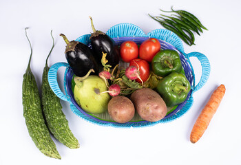 resh and healthy vegetables in a basket on white background flat lay photo