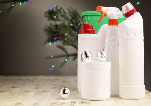 Christmas Cleaning. Botles Of Detergents And Decorations On A Wooden Floor. Holiday Cleaning Concept. 