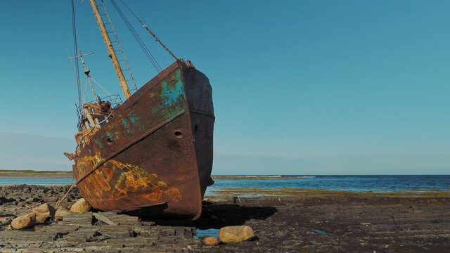 Abandoned ship on the shore of the Barents sea on the Rybachy Peninsula, Russia. Smooth camera movement.