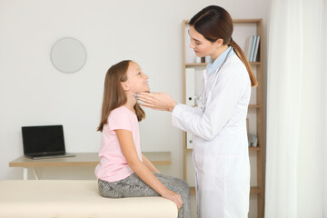 Young girl doctor pediatrician makes a checkup to a little girl