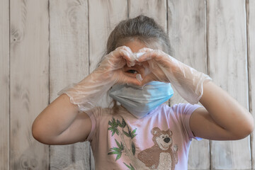 Little girl with a medical mask and disposable gloves. Antivirus. Coronavirus. Hygiene. Prevention Epidemic. Pandemic. The medicine. The fight against the virus. Virus.