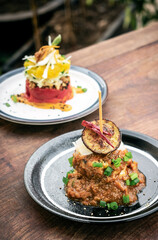 vegan quinoa cakes with roasted eggplant and red pepper sauce
