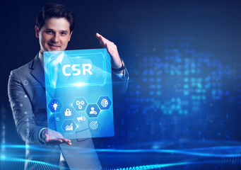 The concept of business, technology, the Internet and the network. A young entrepreneur working on a virtual screen of the future and sees the inscription: CSR