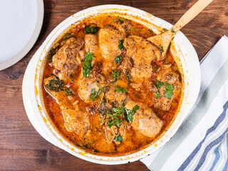 Ready Italian dish - Tuscan chicken with sun-dried tomatoes, tomato paste, spinach, cream and cheese in a frying pan.