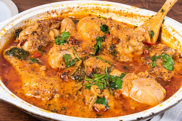 Ready Italian dish - Tuscan chicken with sun-dried tomatoes, tomato paste, spinach, cream and cheese in a frying pan.