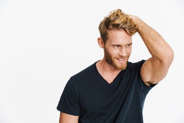 Cheerful caucasian blonde man posing and smiling at camera