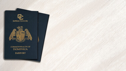 two dominica passports on white wood background, space for texts