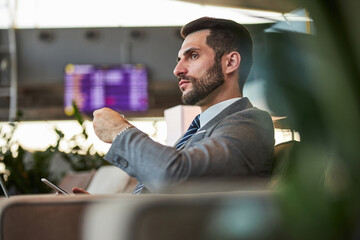 Calm businessperson having a seat at a departure lounge