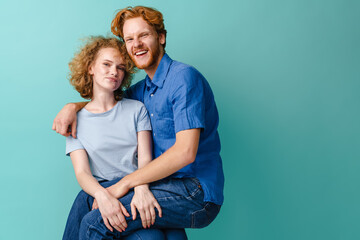 Young happy redhead couple laughing and making fun at camera