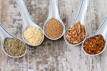 Fine spices and herbs in chinese porcelain spoons