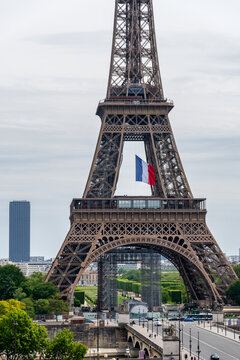 Paris, France - May 11 2020: French flag waving in the middle of the Eiffel Tower during coronavirus lockdown at President Macron request