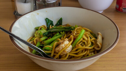 Pad Thai with sea food and greens, traditional Thailand meal, noodles with vegetables