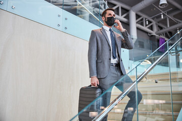 Male on stairs speaking on a cellphone