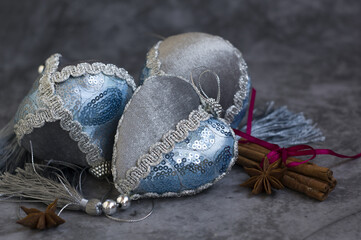 beautiful blue and silver Christmas tree decorations, cinnamon sticks on gray background