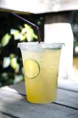 Lemon and honey soda in a glass are placed on the table.