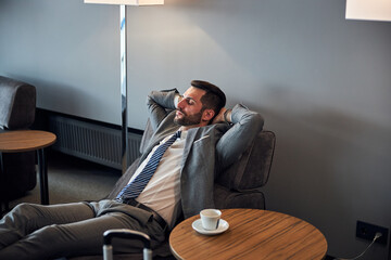 Businessman is napping on a small bed