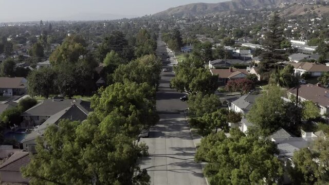 Burbank California ordinary residential suburban houses aerial view moving along neighbourhood roads & gardens