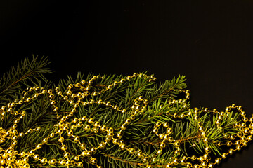 Background with a spruce branch, New Year's beads. Congratulatory Christmas background with place for text.