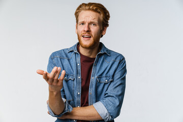 Nervous handsome guy resenting and pointing finger at camera