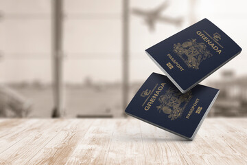 Two grenada passports are floating in the air, on a wood table, airport waiting room