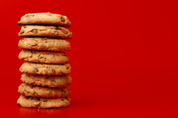 Chocolate chip cookies in stack on red background