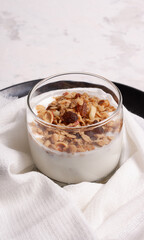 Healthy breakfast. Yogurt with granola, nuts, fruits. On a black background.