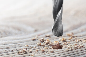 metal drill bit make holes in old wooden plank