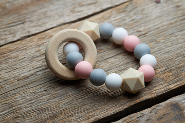 Colorful silicone teether on wooden background