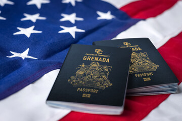 two grenada passport on a usa flag