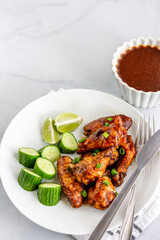 Barbecue Thai Chicken Wings with Condiment Directly Above Vertical Photo on White Background
